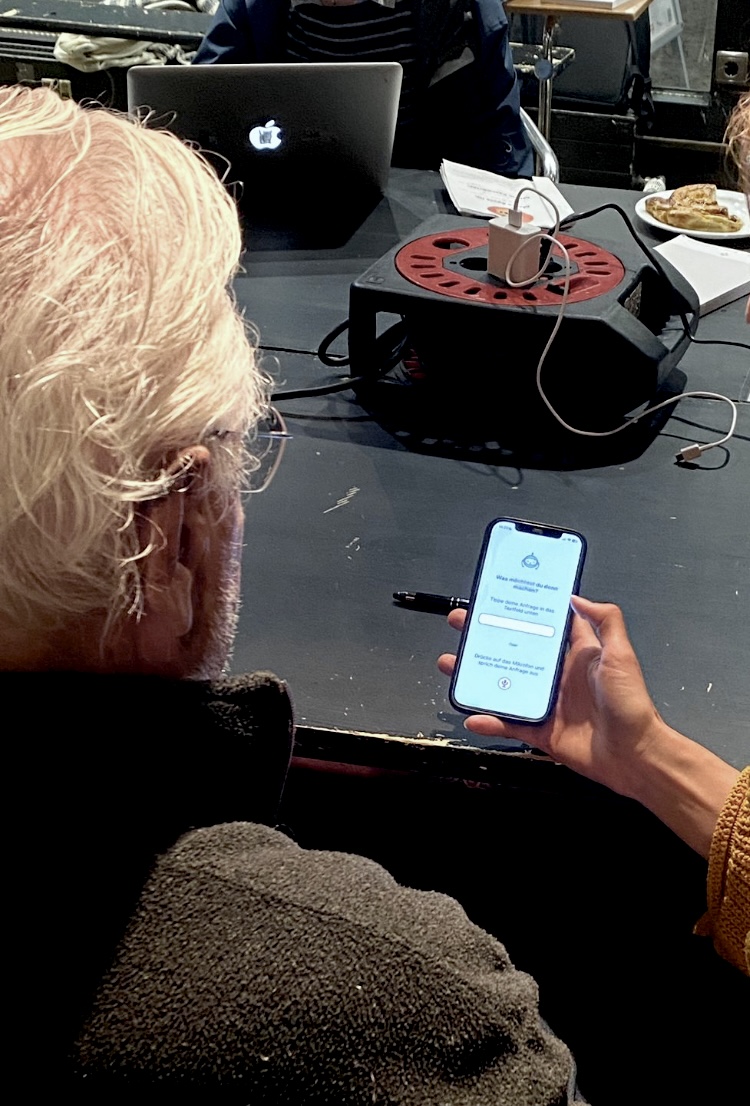 A senior tries the first prototype on a phone during a testing session